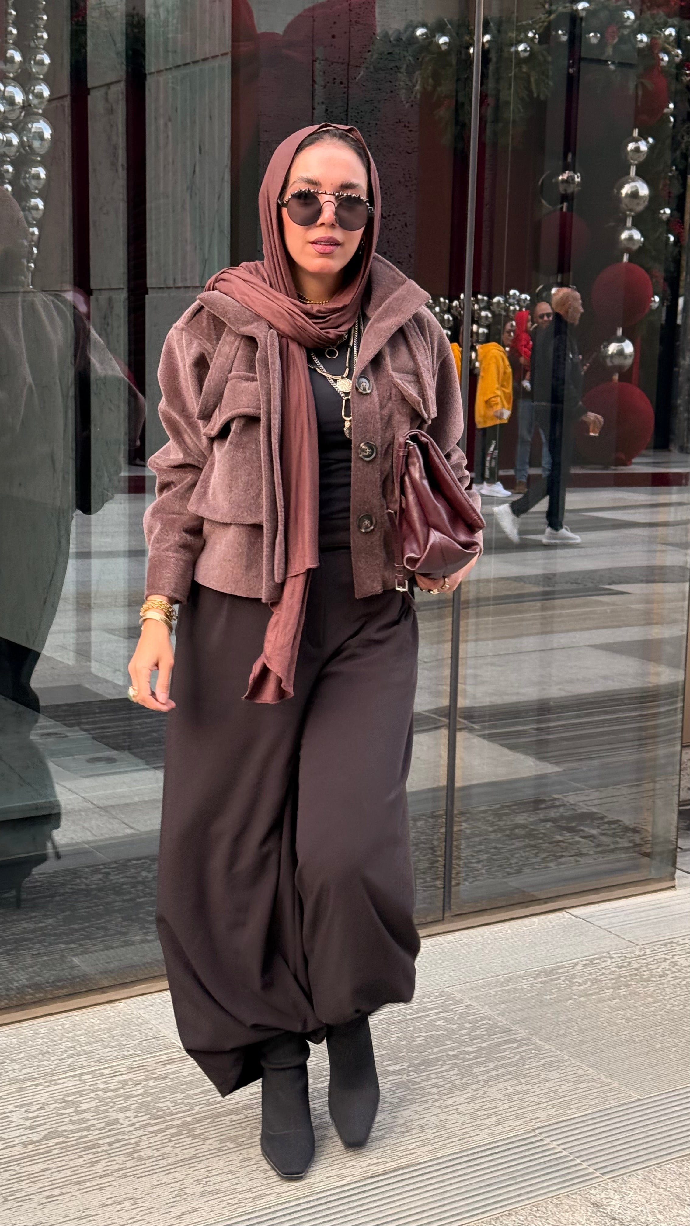 Cropped fur jacket in a brown color.