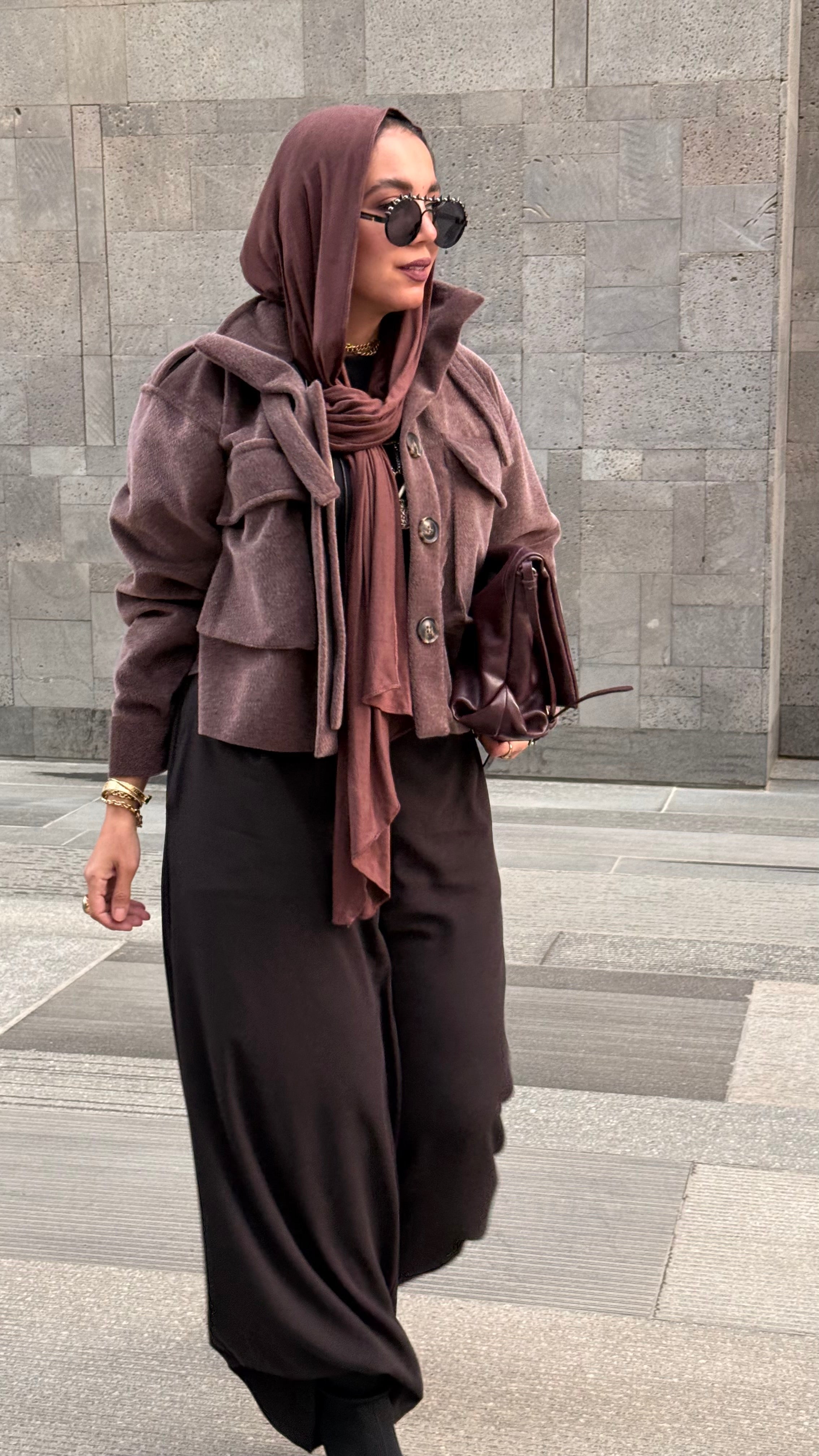 Cropped fur jacket in a brown color.