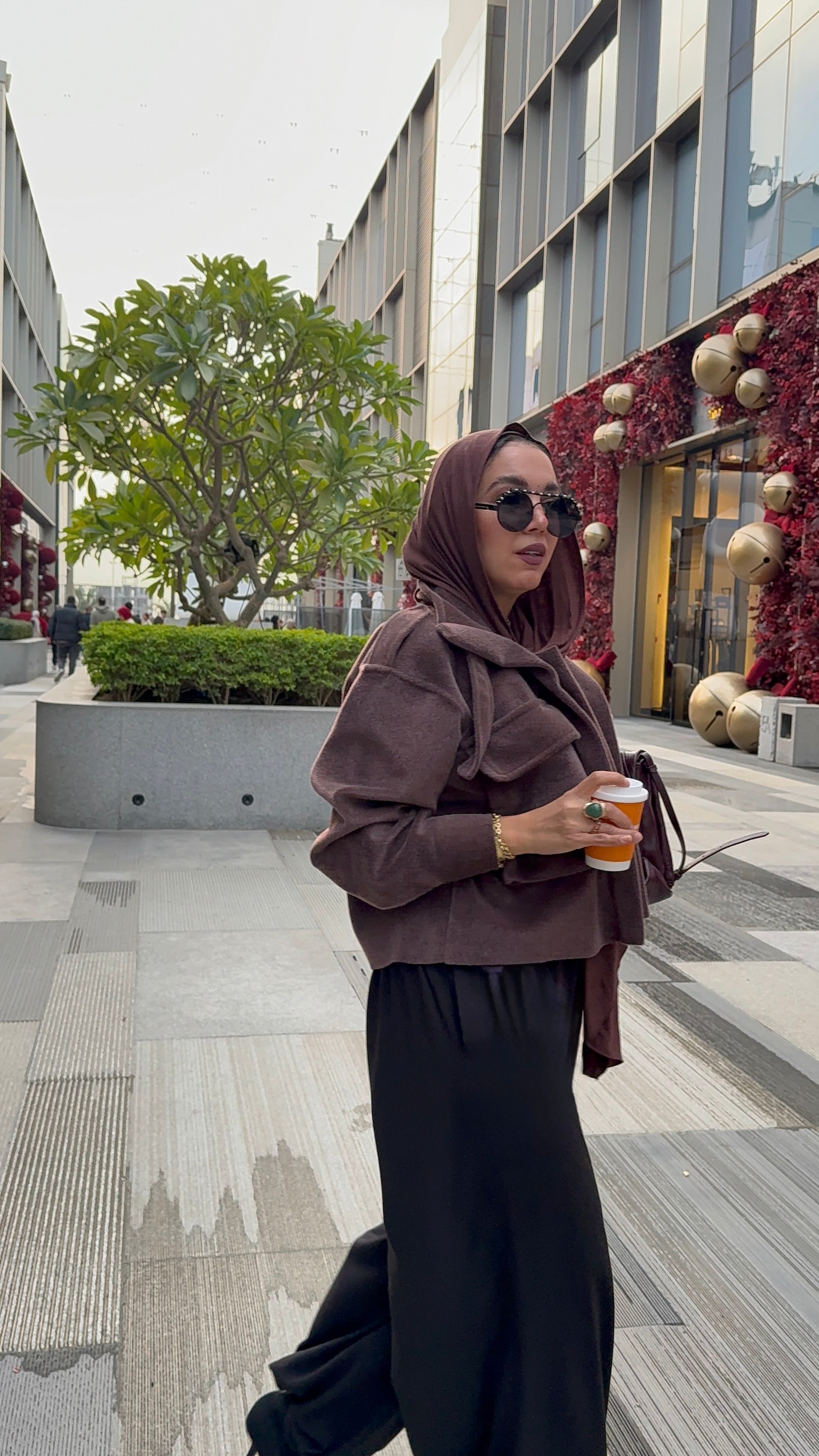 Cropped fur jacket in a brown color.