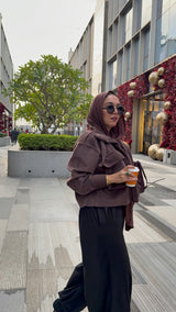 Cropped fur jacket in a brown color.